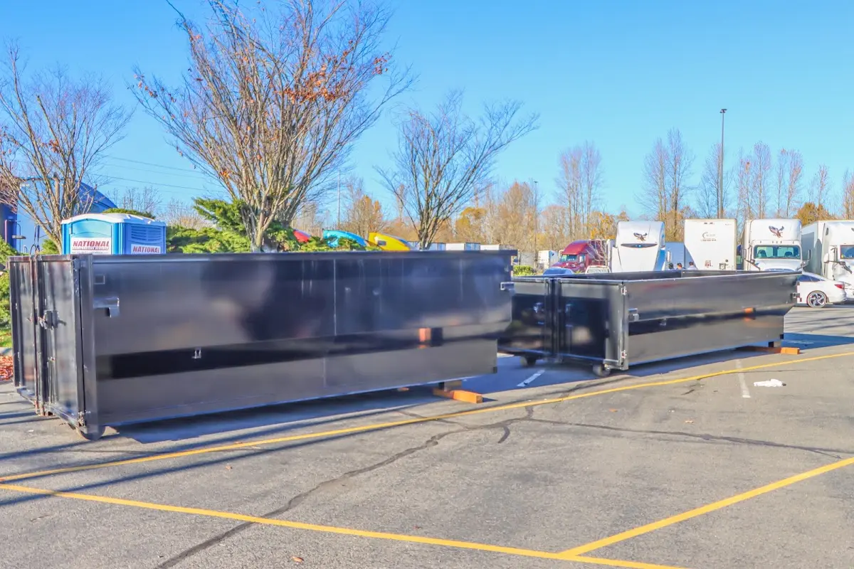 Professional dumpster rental service with roll-off container on residential driveway in Spencer